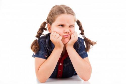 Angry little young girl child, isolated on white background