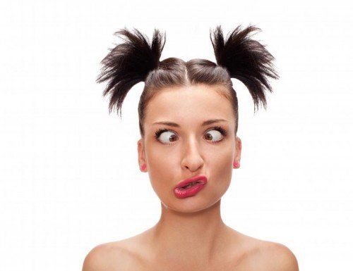 squint eyed woman with weird expression isolated on white