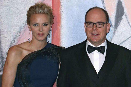 Prince Albert II of Monaco, and his wife Princess Charlene pose for photographers as they arrive at the Rose Ball for the 50th anniversary of the Princess Grace Foundation, in Monaco, Saturday, March 29, 2014. (AP Photo)