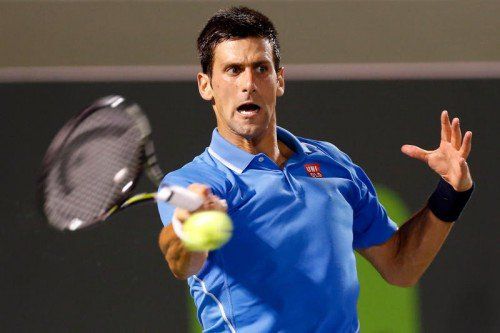 Apr 2, 2015; Key Biscayne, FL, USA; Novak Djokovic hits a forehand against David Ferrer (not pictured) in a men's singles quarter-final on day eleven of the Miami Open at Crandon Park Tennis Center. Djokovic won 7-5, 7-5. Mandatory Credit: Geoff Burke-USA TODAY Sports
