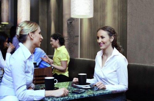Two businesswomen enjoying coffee break