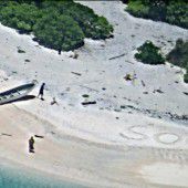 SOS-Nachricht im Sand rettet Gestrandete