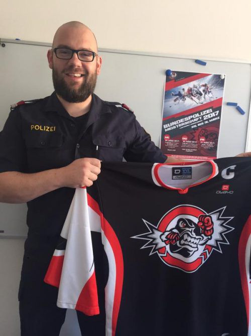 Der 34-Jährige in Dienstuniform präsentiert als Vorarlbergs Eishockey-Sektionsleiter stolz den Dress seiner Mannschaft. Foto: VN/Sohm