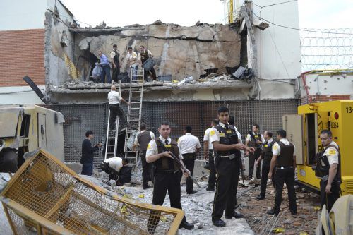 Polizisten untersuchen den Tresorraum, den die Verbecher in Ciudad del Este in Paraguay sprengten und daraus Geld erbeuteten. Foto: AP