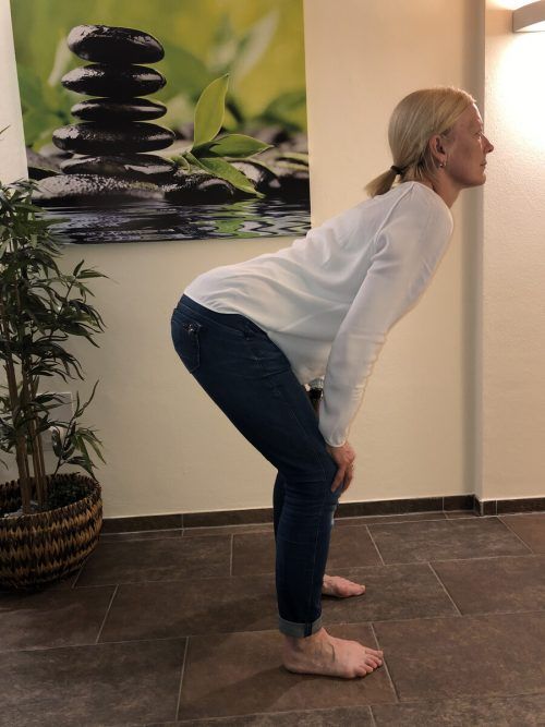 Sanftes Rücken-Workout. Ausgangsstellung: Stelle dich hüftbreit hin, gehe leicht in die Knie, stütze deine Hände auf den Oberschenkeln auf. Dein Rücken bleibt aufrecht und gerade, dein Kopf ist die Verlängerung deiner Wirbelsäule. Beginne nun, deine Wirbelsäule in einem gleichmäßigen Bogen vom Hals bis zum Steißbein einzurollen (Katzenbuckel) – atme dabei aus. Nun rolle wieder Wirbel für Wirbel auf – hebe dabei langsam deinen Kopf und ziehe auch dein Gesäß nach oben, so dass du deinen hinteren Oberschenkel auch spürst – atme ein.Ziel: Zehn bis 20 Wiederholungen