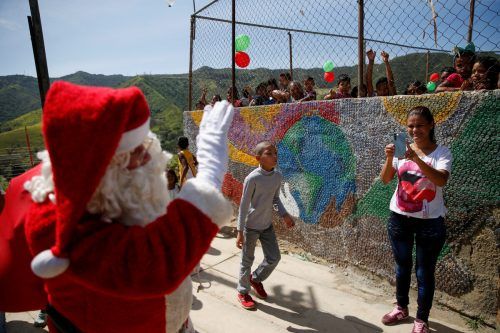 In einer einkommensschwachen Gegend der venezolanischen Hauptstadt Caracas freuen sich Kinder über den Besuch vom Weihnachtsmann. REUTERS