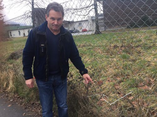 Auf der anderen Straßenseite: Tschofen zeigt auf einen Rest der Kabelbinder, dort, wo er das Gespann vom Maschendraht riss.  VN/GS