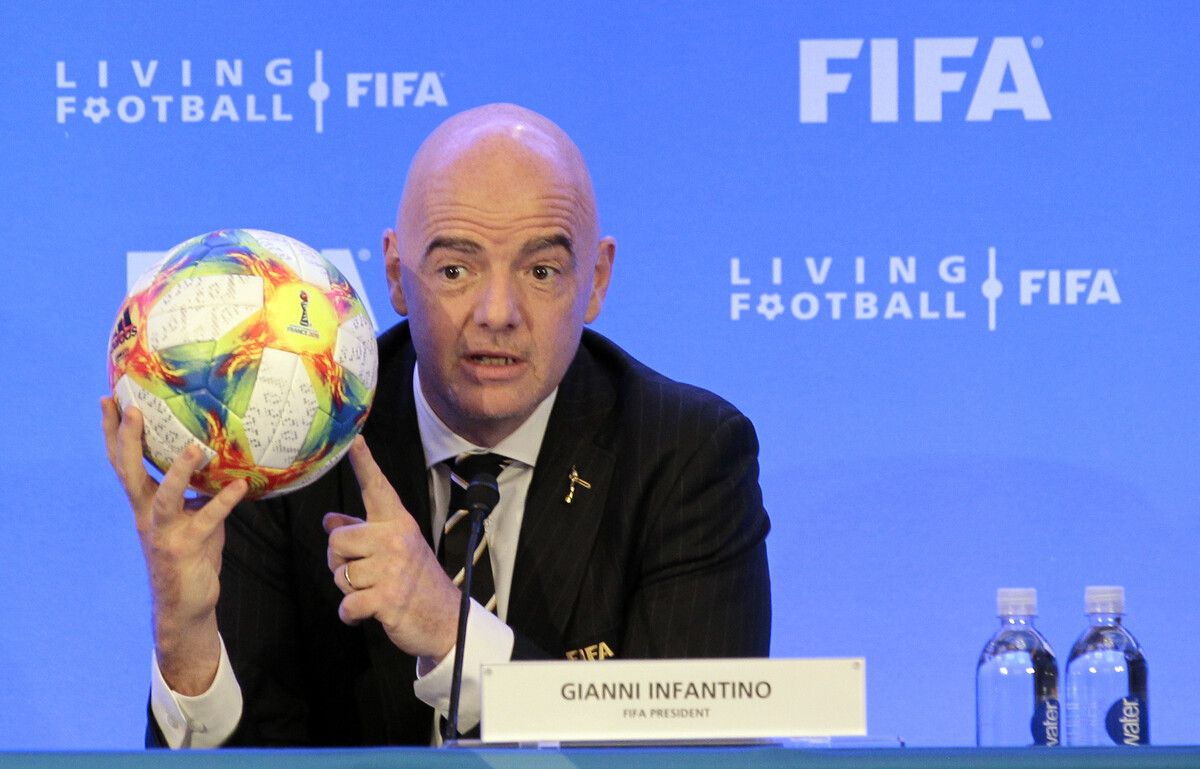 FILE - FIFA President Gianni Infantino holds a soccer ball as he speaks during a press conference after the FIFA Council Meeting, Friday, March 15, 2019, in Miami. FIFA is moving more than 100 jobs from its Swiss headquarters to Florida where a growing workforce is already working on organizing the 2026 World Cup. FIFA informed staff Tuesday, Sept. 26, 2023 the entire legal department plus audit, compliance and risk management teams will move from Zurich to Coral Gables near Miami. (AP Photo/Luis M. Alvarez, File)