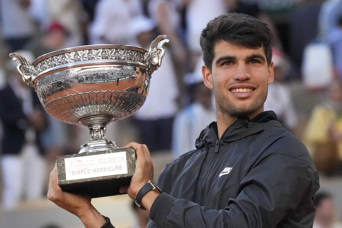 Spain's Carlos Alcaraz holds the trophy after winning the men's final of the French Open tennis tournament against Germany's Alexander Zverev at the Roland Garros stadium in Paris, France, Sunday, June 9, 2024. (AP Photo/Christophe Ena)