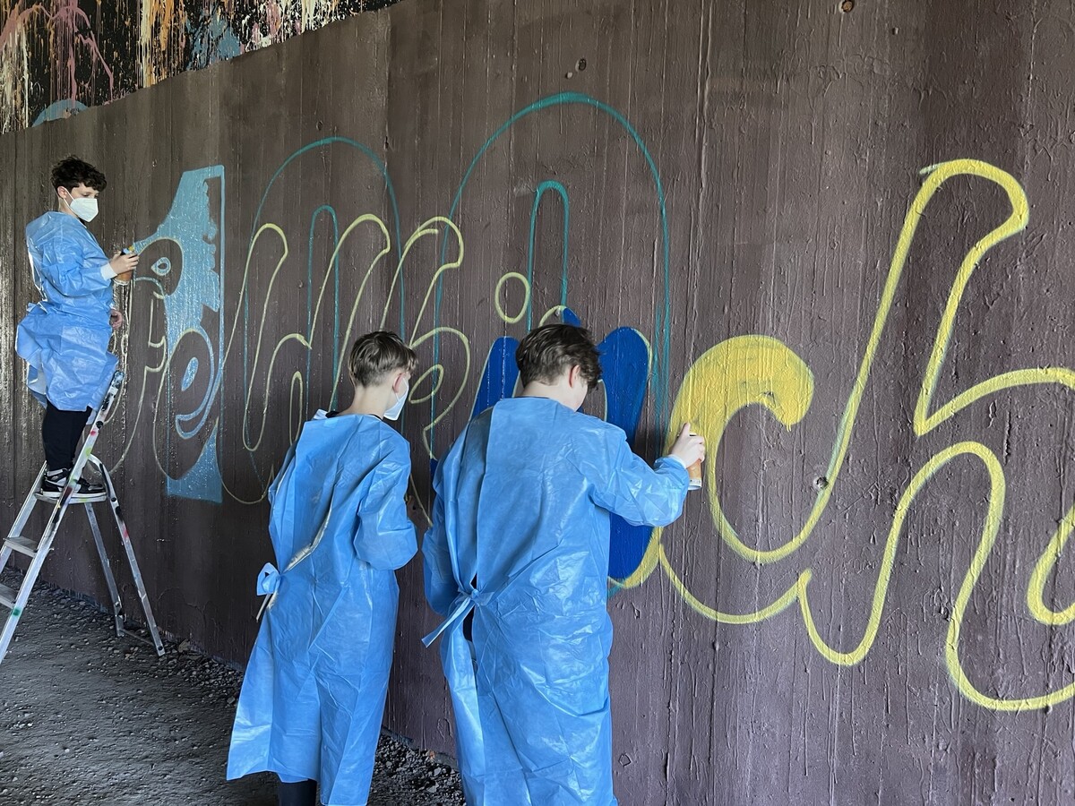 Schüler gestalten mit viel Freude Graffitis in der Unterführung. ⇒fabian hämmerle