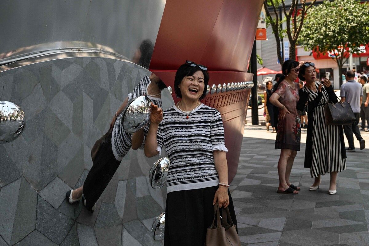 Menschen posieren in Shanghai vor „The Louis“ – einer großen, schiffsförmigen Installation der Marke Louis Vuitton. AFP