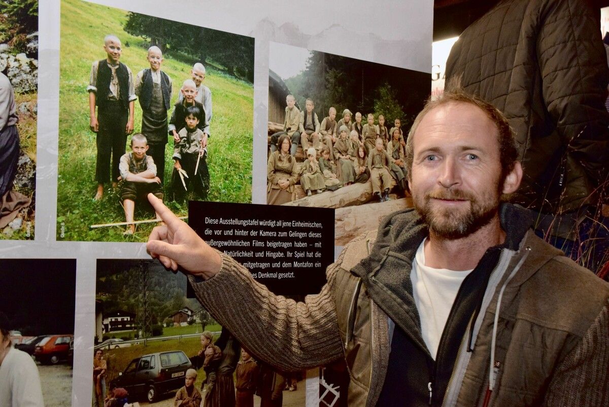 Alexander Hechenberger zeigt auf ein Bild, auf dem er gemeinsam mit anderen jungen „Schlafes Bruder“-Filmdarstellern im Sommer 1994 zu sehen ist. ⇒SCO