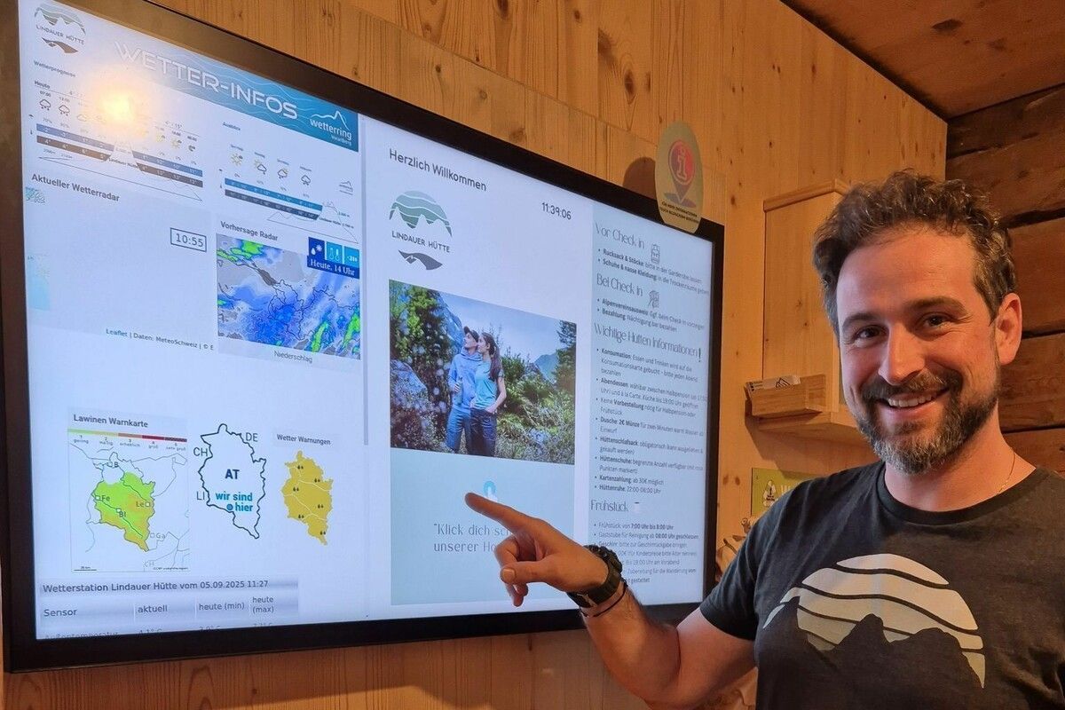 Der Hüttenwirt Stefan Köberle präsentiert den Informationsbildschirm, der extra angeschafft wurde. ⇒Franziska Eckert