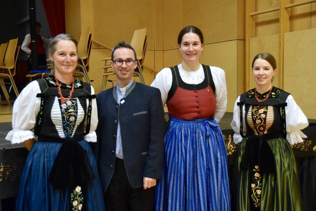 Pfarrer und Konzertmoderator Lukas Bonner mit den Marketenderinnen Kathrin (l.) und Stefanie (r.) sowie Musikantin Ronja (2. v. r.).