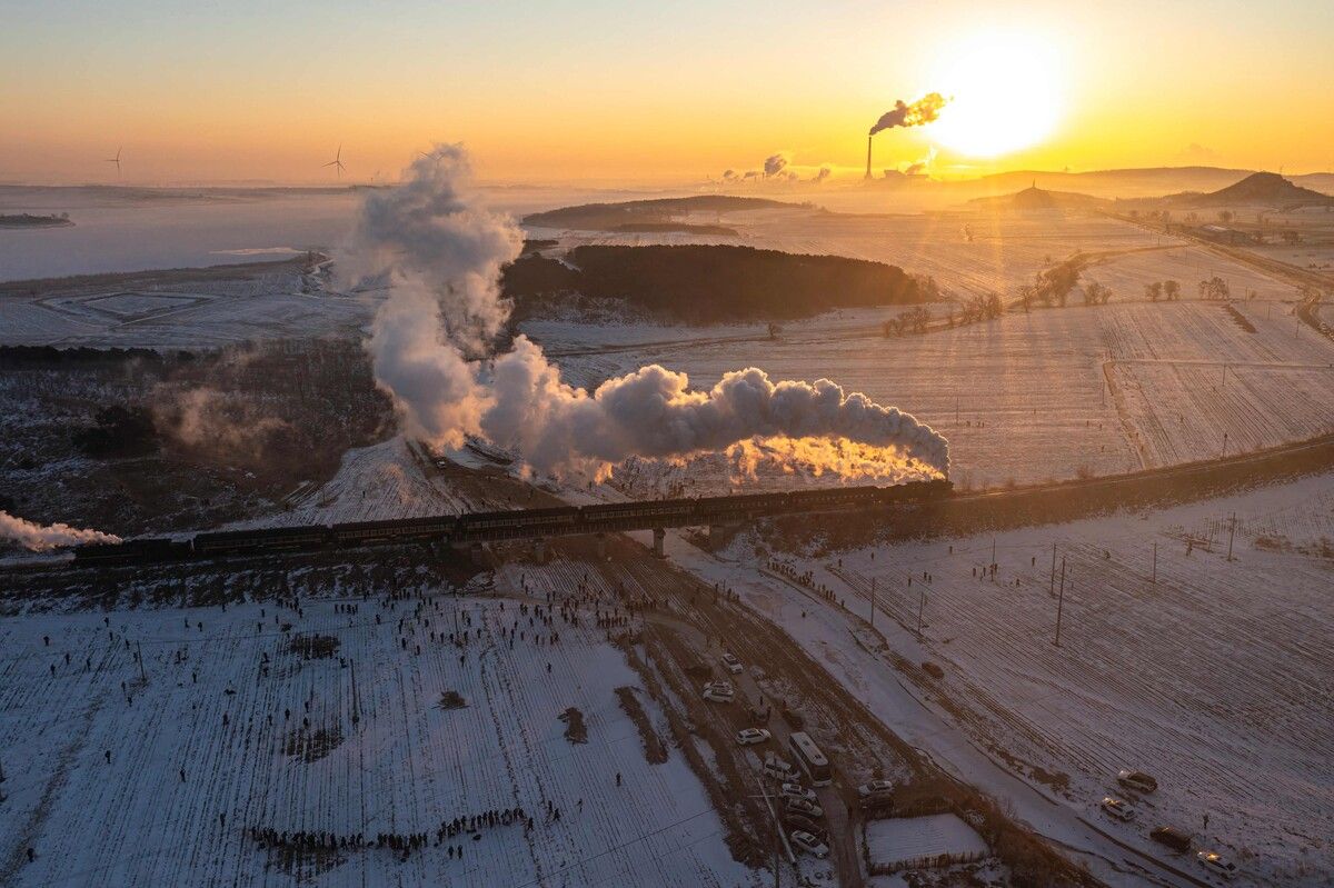 Eine Dampflokomotive fährt bei Sonnenaufgang auf den Gleisen von Diaobingshan in Nordostchina, wo die internationale Dampflok-Tourismussaison feierlich eröffnet wird. afp (5)