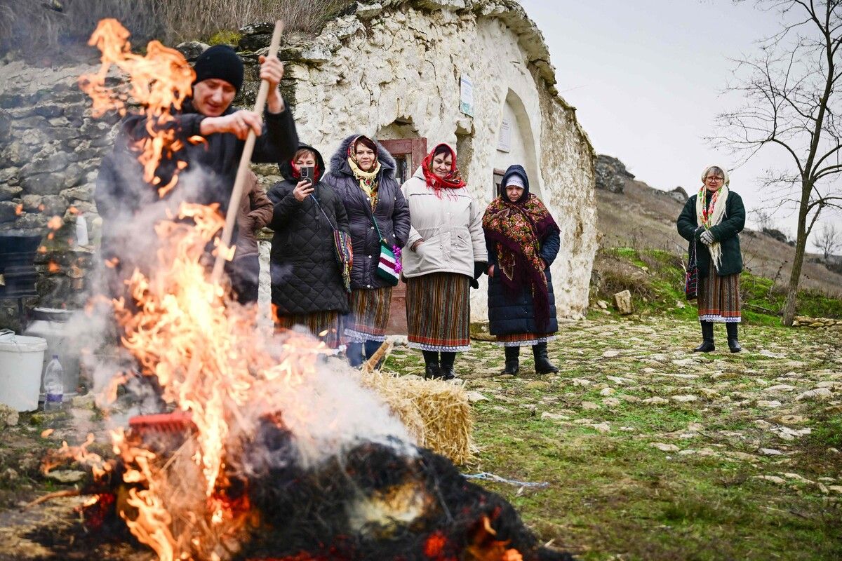 Frauen in traditioneller moldauischer Tracht beobachten in Rogojeni die traditionelle Schweineschlachtung, mit der das Dorf seine Bräuche pflegt und Touristen anziehen möchte. afp (5)