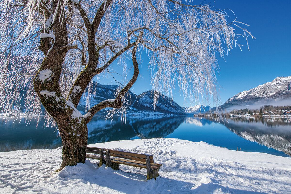 Winterlicher Blick auf den Grundlsee: Verschneite Ufer und klares Wasser prägen das Bild in der kalten Jahreszeit. Shutterstock (ALLE)