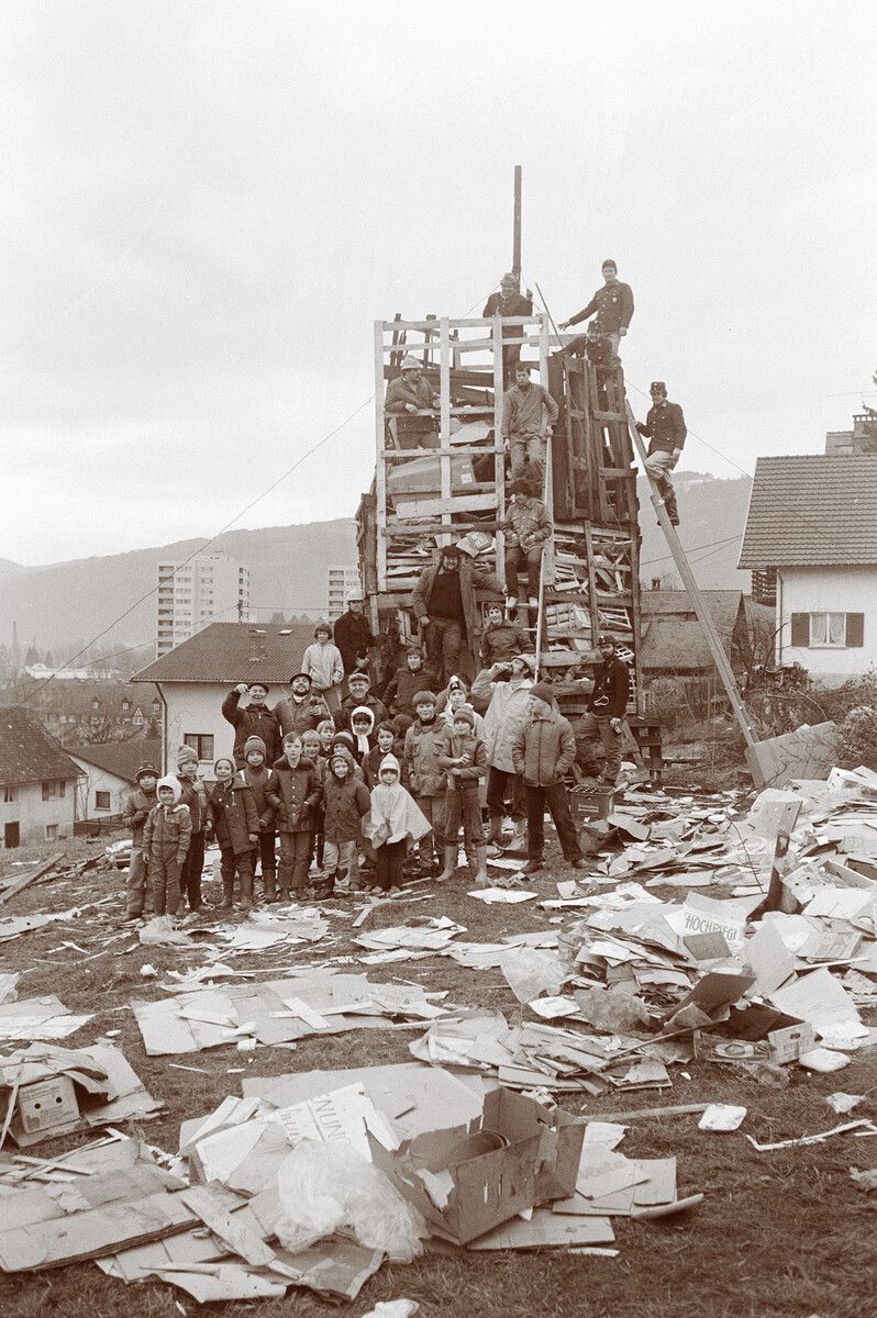 Bregenz-Rieden 1980: Der Funken wächst aus Brettern und Karton, und das halbe Viertel packt mit an. ⇒Oskar Spang, Helmut Klapper, Sammlung Nikolaus Walter, Vorarlberger Landesbibliothek