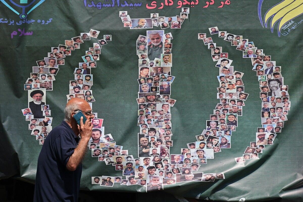 Ein Mann geht in Teheran an einem am Straßenrand aufgestellten Banner voller Fotos vorbei. AFP (3), APA (2)